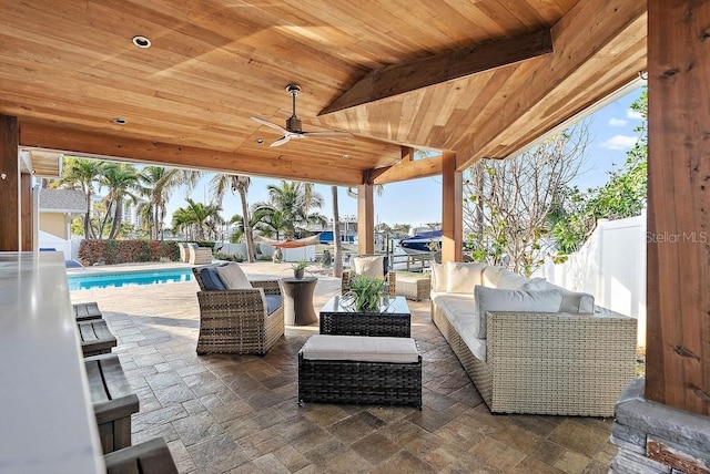 view of patio featuring an outdoor living space, a fenced in pool, and ceiling fan