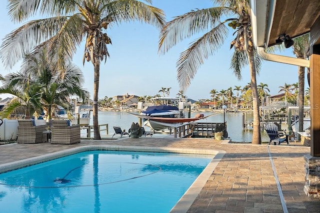 view of pool with a water view and a dock