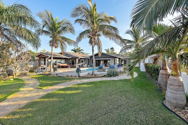 exterior space with an outdoor living space, a patio, and a lawn