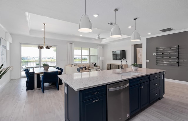 kitchen with a kitchen island with sink, hanging light fixtures, stainless steel dishwasher, and a raised ceiling