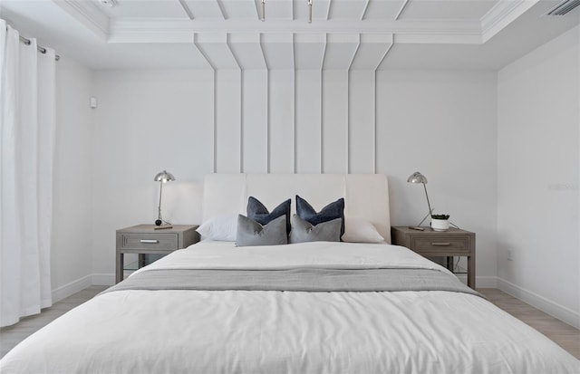 bedroom featuring ornamental molding and light hardwood / wood-style floors