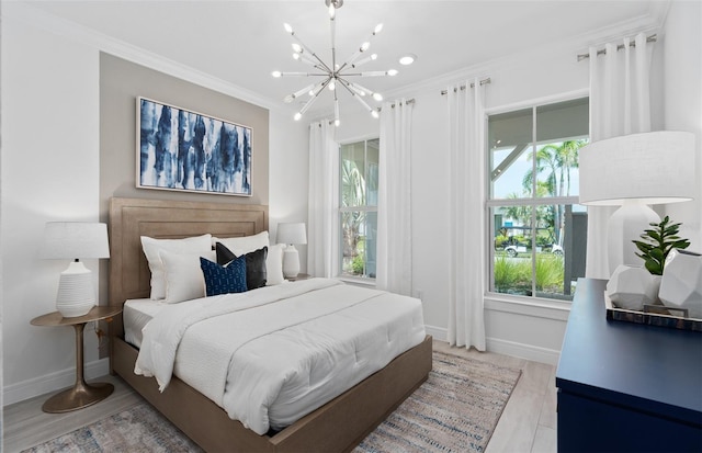 bedroom with ornamental molding, light hardwood / wood-style floors, and a chandelier