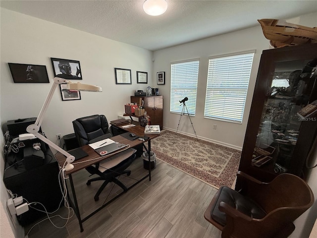 office area with wood-type flooring and a textured ceiling