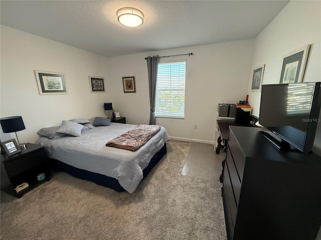 bedroom featuring carpet floors and a textured ceiling