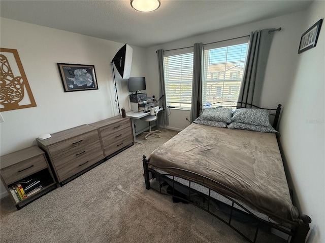 bedroom with carpet and a textured ceiling