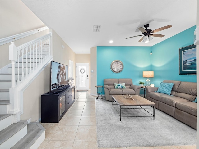 living room featuring light tile patterned floors and ceiling fan