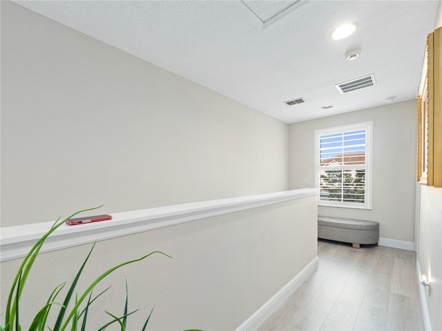 hall with light hardwood / wood-style floors