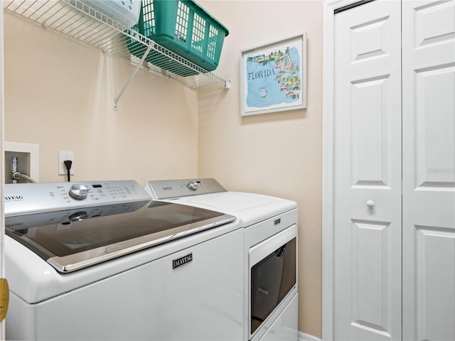 clothes washing area with separate washer and dryer