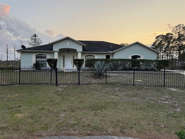 single story home with a lawn