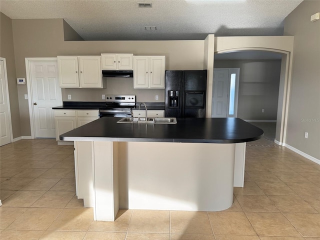 kitchen featuring an island with sink, sink, black refrigerator with ice dispenser, and electric range