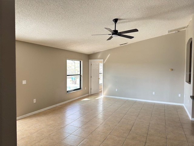 unfurnished room with light tile patterned floors, a textured ceiling, and ceiling fan