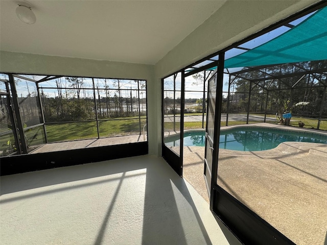 view of pool with a patio and glass enclosure