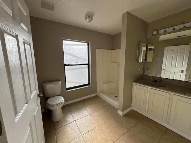 bathroom featuring a shower, tile patterned flooring, vanity, toilet, and a textured ceiling