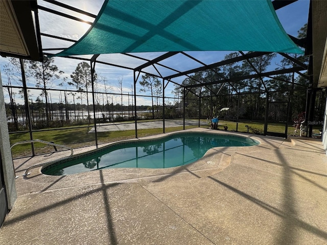 view of pool with a patio and glass enclosure