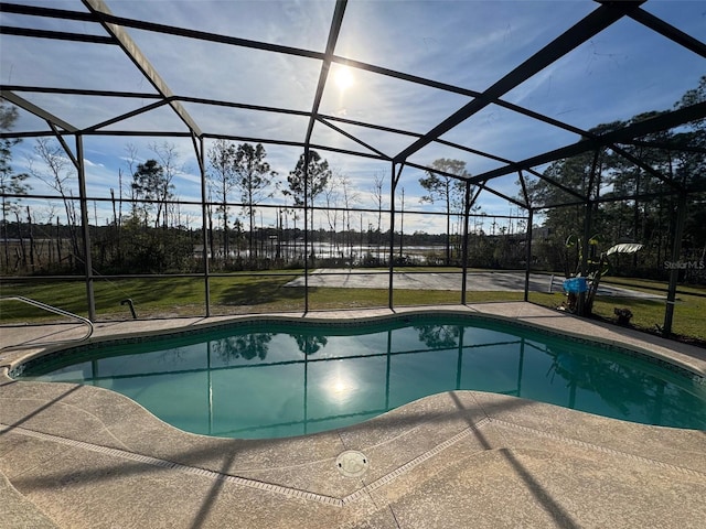 view of swimming pool featuring a patio and glass enclosure