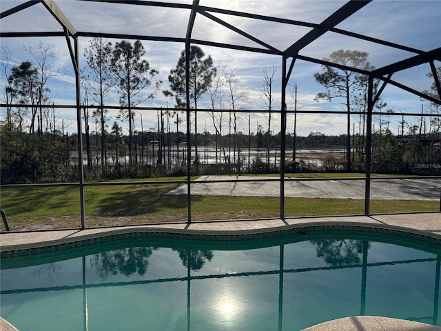 view of swimming pool with a lanai