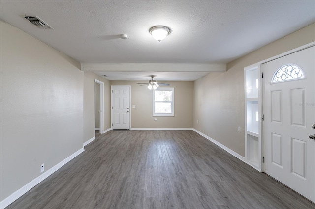 entrance foyer featuring dark hardwood / wood-style floors and a textured ceiling