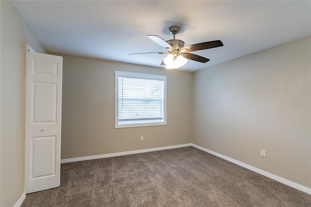 unfurnished room with ceiling fan and carpet flooring