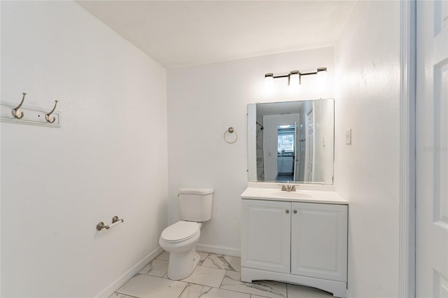 bathroom with vanity, toilet, and a shower