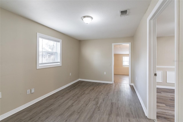 unfurnished room with hardwood / wood-style floors