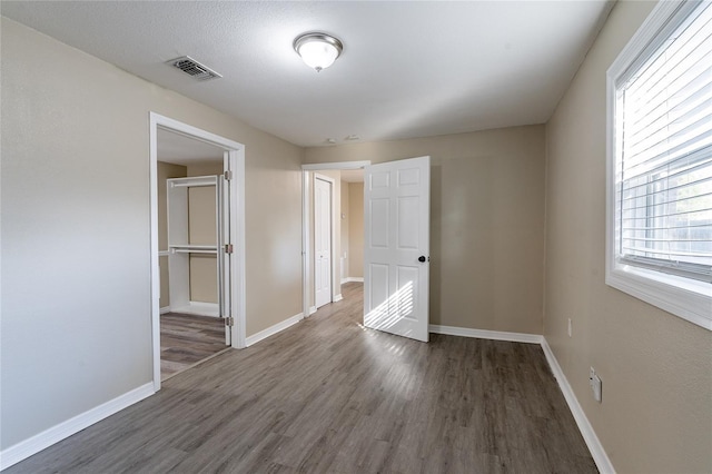 unfurnished bedroom featuring dark hardwood / wood-style floors