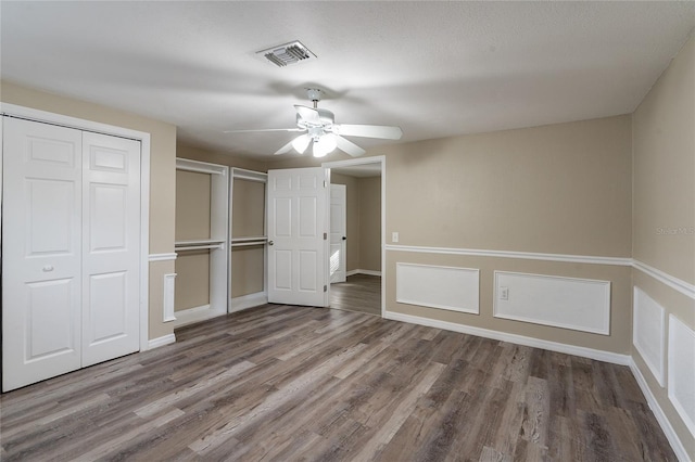 unfurnished bedroom featuring wood-type flooring and ceiling fan