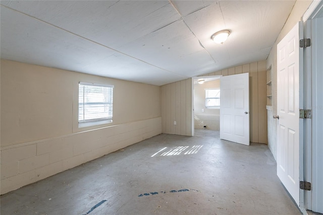 spare room with lofted ceiling and a wealth of natural light