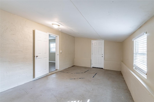 unfurnished room featuring concrete flooring