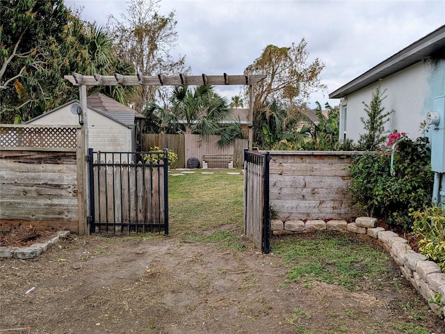 view of gate featuring a lawn