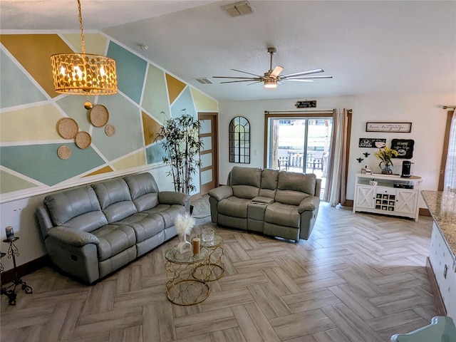 living room featuring light parquet flooring, lofted ceiling, and ceiling fan with notable chandelier