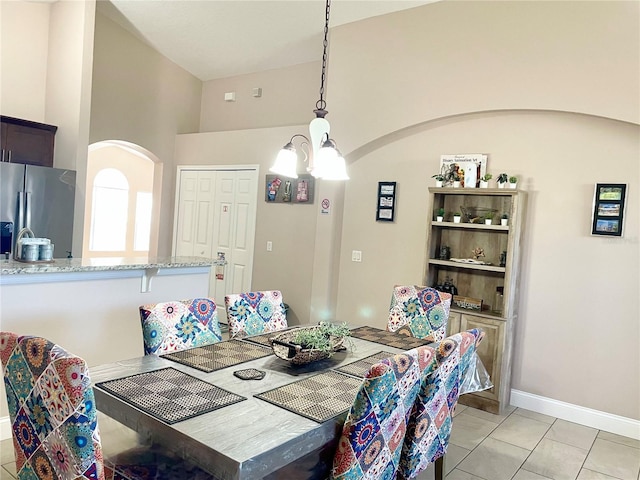 tiled dining area featuring a notable chandelier