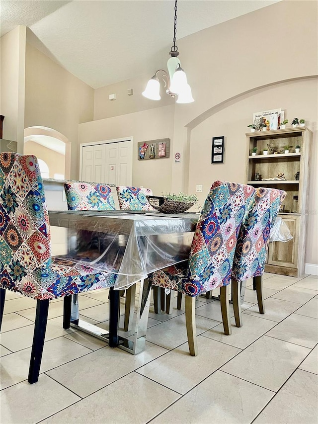 dining area featuring a notable chandelier and tile patterned floors