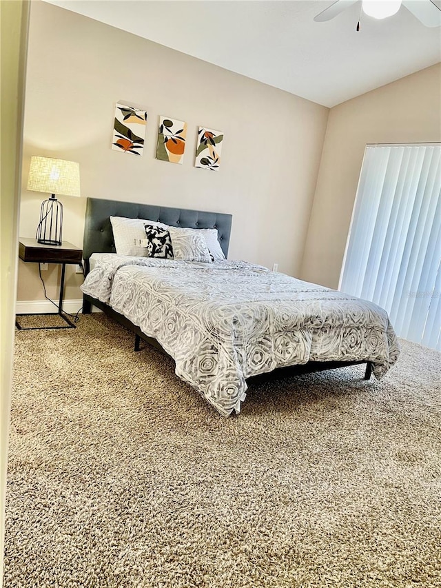 carpeted bedroom with vaulted ceiling and ceiling fan