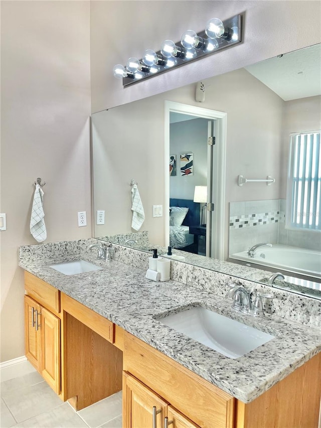 bathroom featuring tile patterned flooring, vanity, and a bathtub