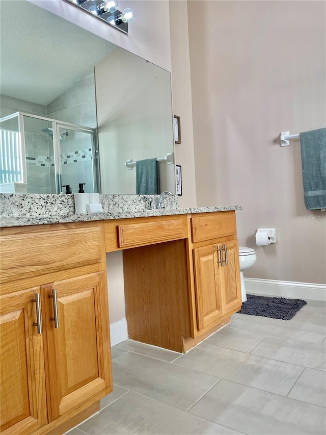 bathroom featuring vanity, an enclosed shower, tile patterned flooring, and toilet