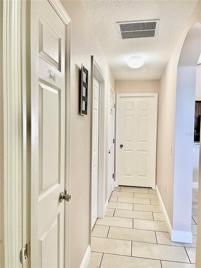 hallway featuring a textured ceiling