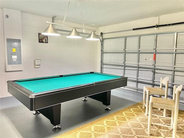 playroom featuring pool table, concrete flooring, and electric panel