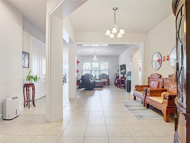 tiled foyer with a notable chandelier