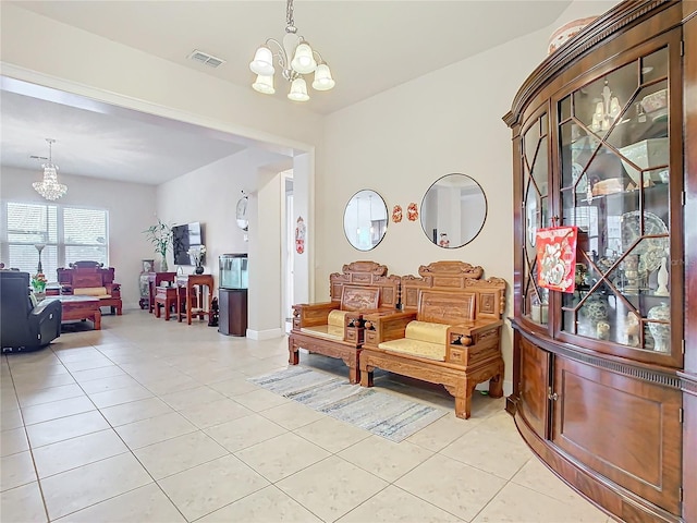 sitting room featuring light tile patterned floors and a chandelier