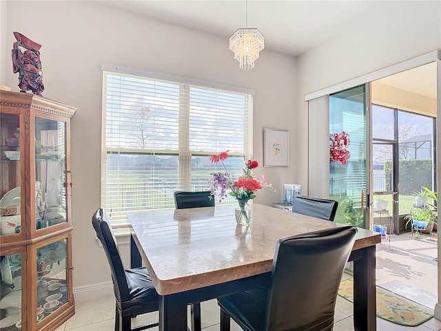 dining space featuring a wealth of natural light, an inviting chandelier, and light tile patterned floors