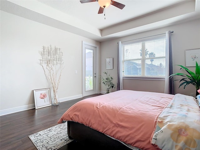 bedroom with access to exterior, dark wood-type flooring, and ceiling fan