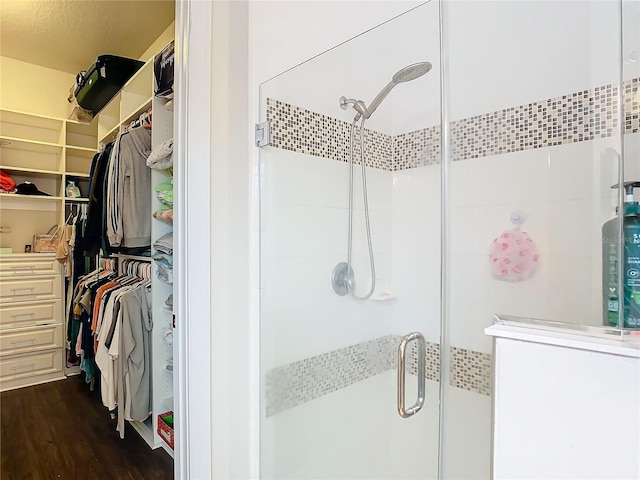 bathroom with hardwood / wood-style floors and walk in shower