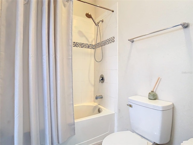 bathroom featuring shower / bath combo and toilet