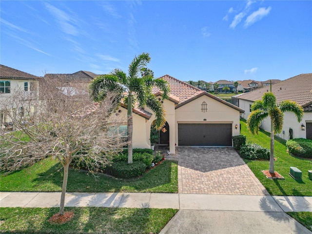 mediterranean / spanish-style home featuring a garage and a front yard