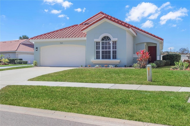 mediterranean / spanish-style home featuring a garage and a front lawn