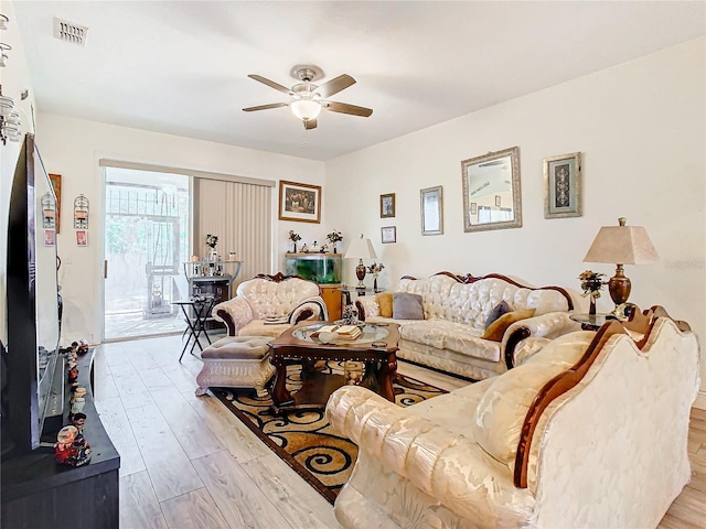 living room featuring ceiling fan and light hardwood / wood-style flooring