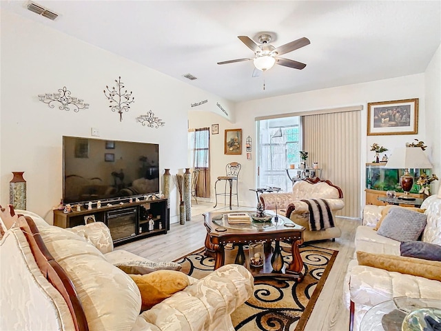 living room with ceiling fan and light wood-type flooring