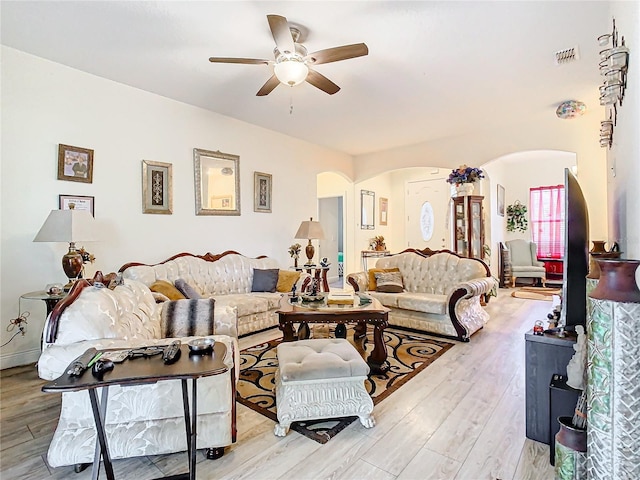 living room with light hardwood / wood-style flooring and ceiling fan