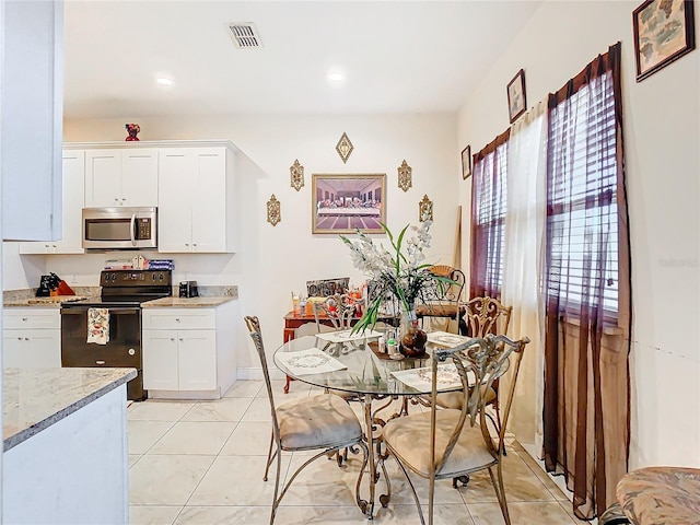 dining space with light tile patterned floors