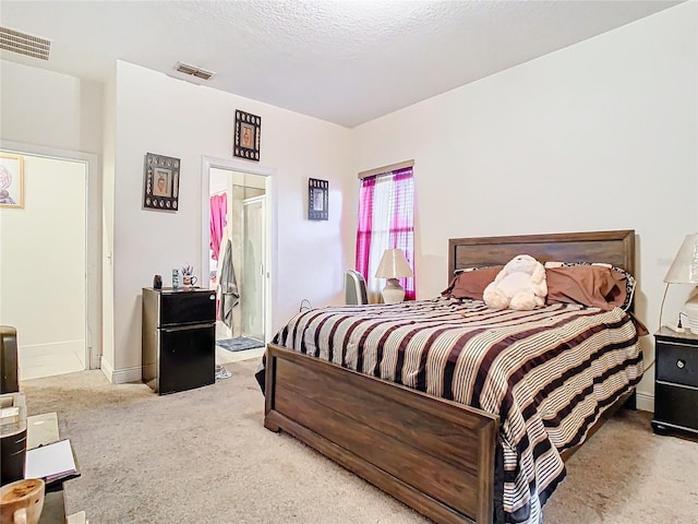 bedroom with carpet and a textured ceiling